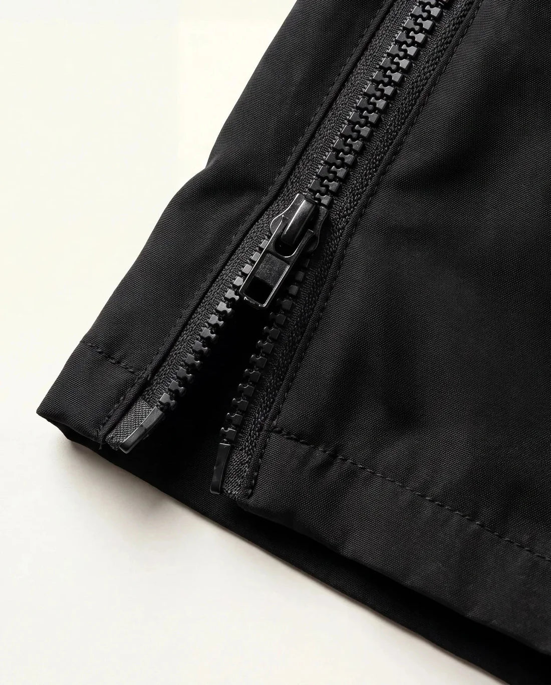 Detalhe do zíper lateral da barra da calça baggy masculina preta Prison